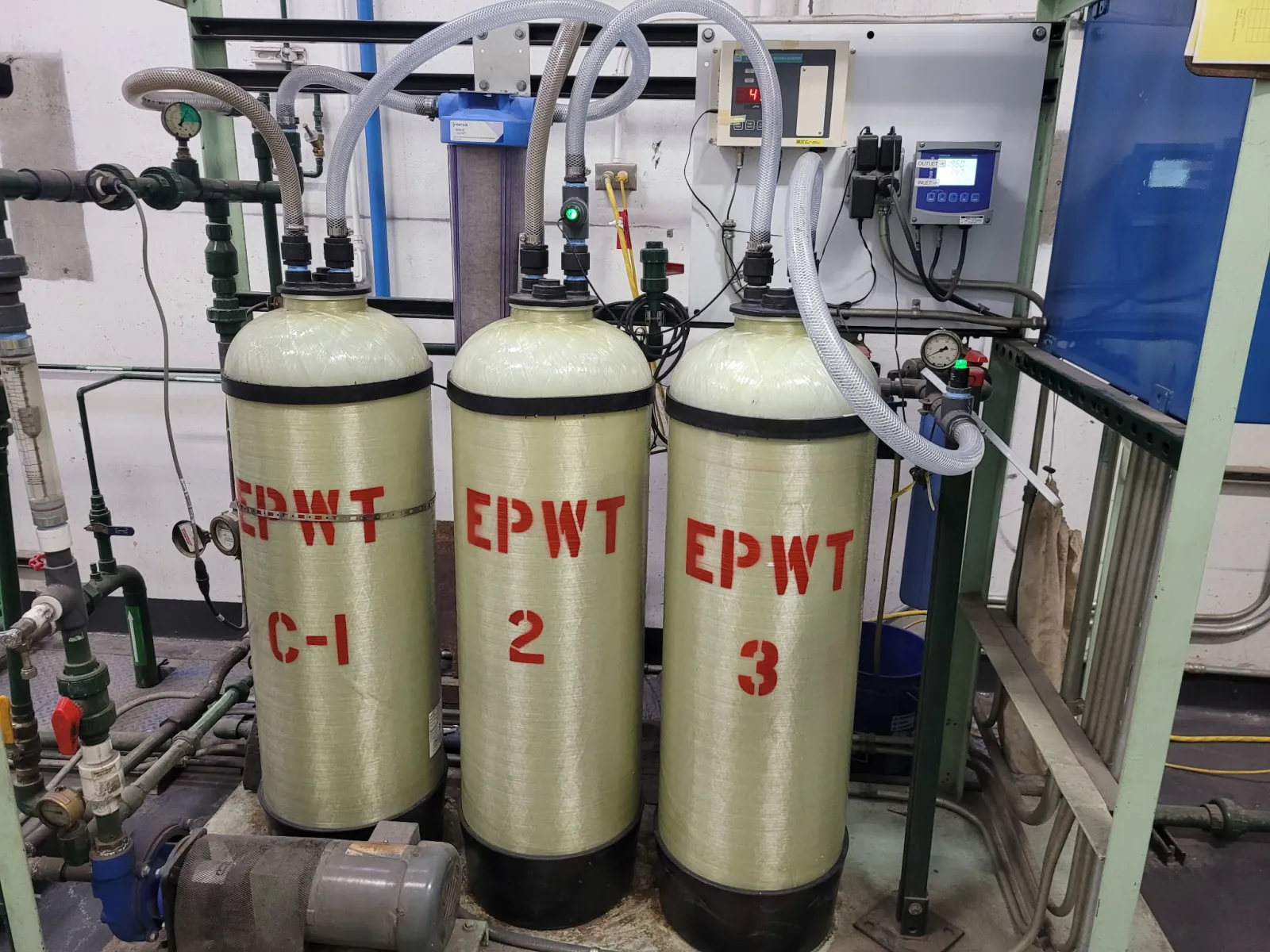 Three El Paso Water Tek deionization tanks connected to process piping and water-quality monitoring equipment